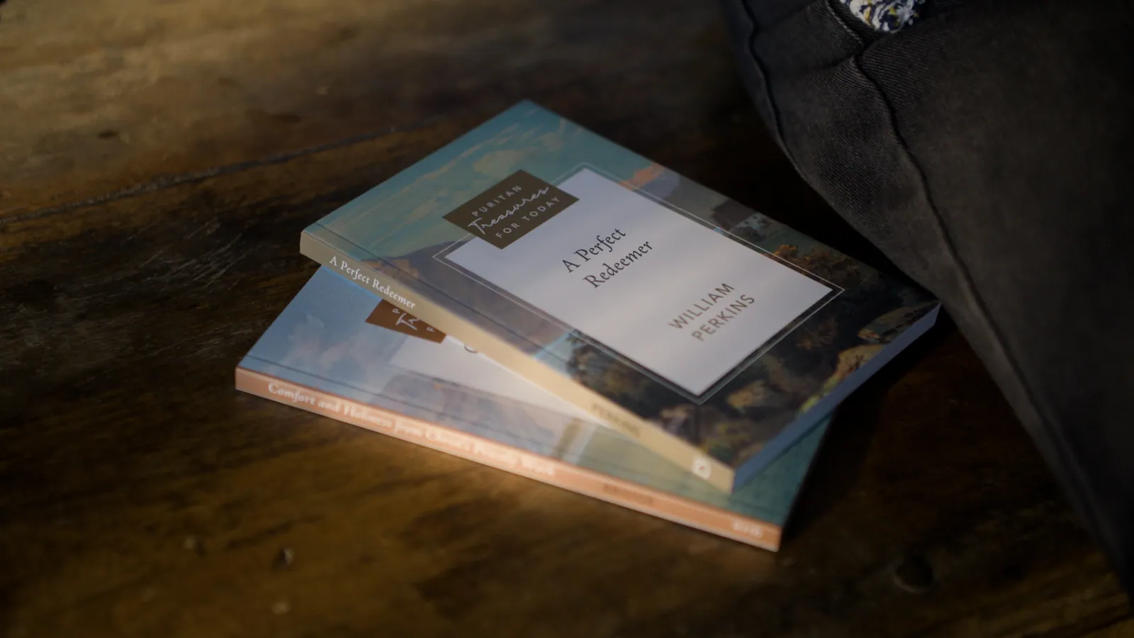 Two Puritan Treasures for Today paperbacks on a rough wooden table.